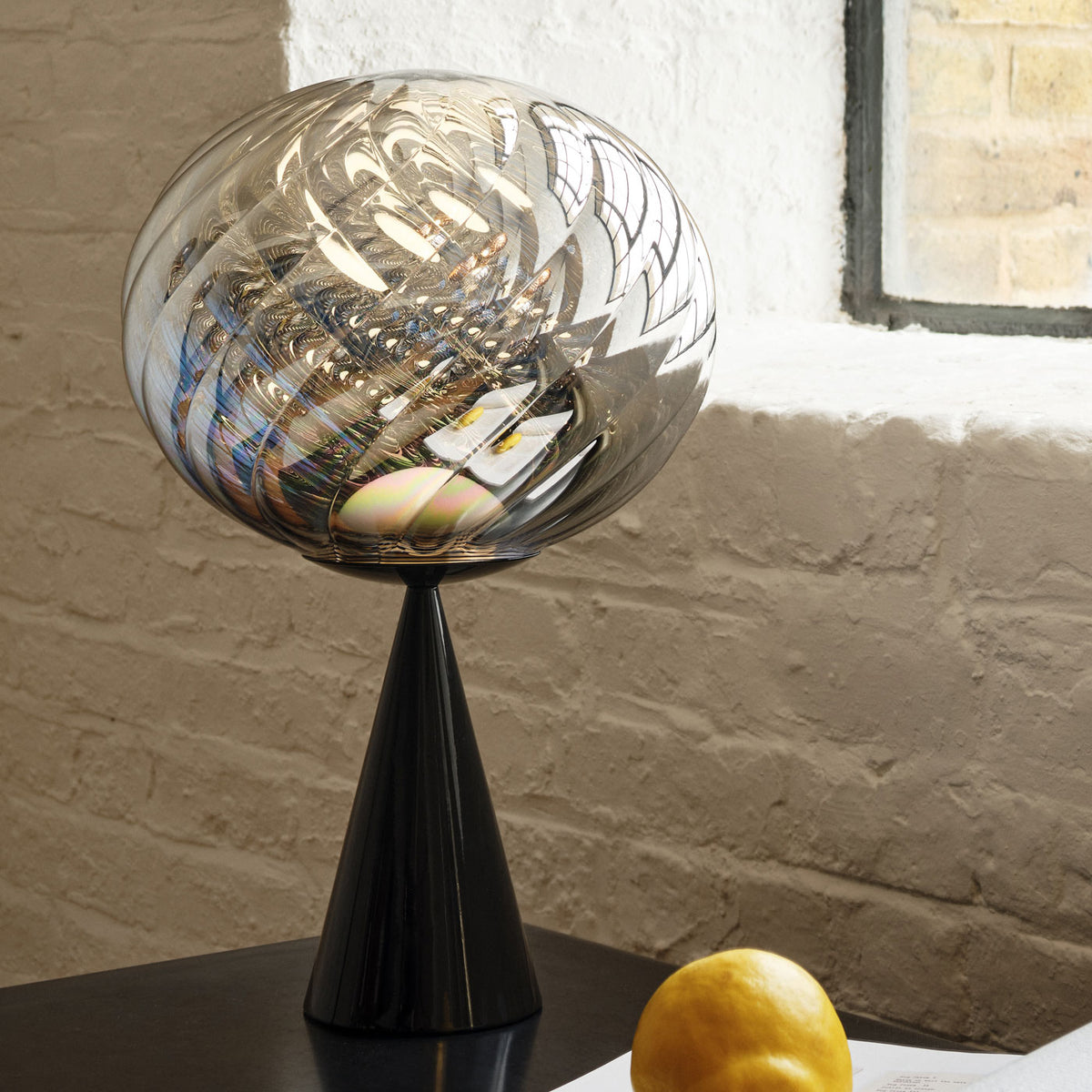 Tom Dixon Whirl Table Light in silver polished polycarbonate with black hardware, official white-background view