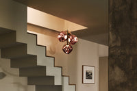 Tom Dixon Melt Mini Chandelier in copper in an official interior setting