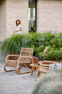 Curve lounge chair outdoor lifestyle image by Cane-line
