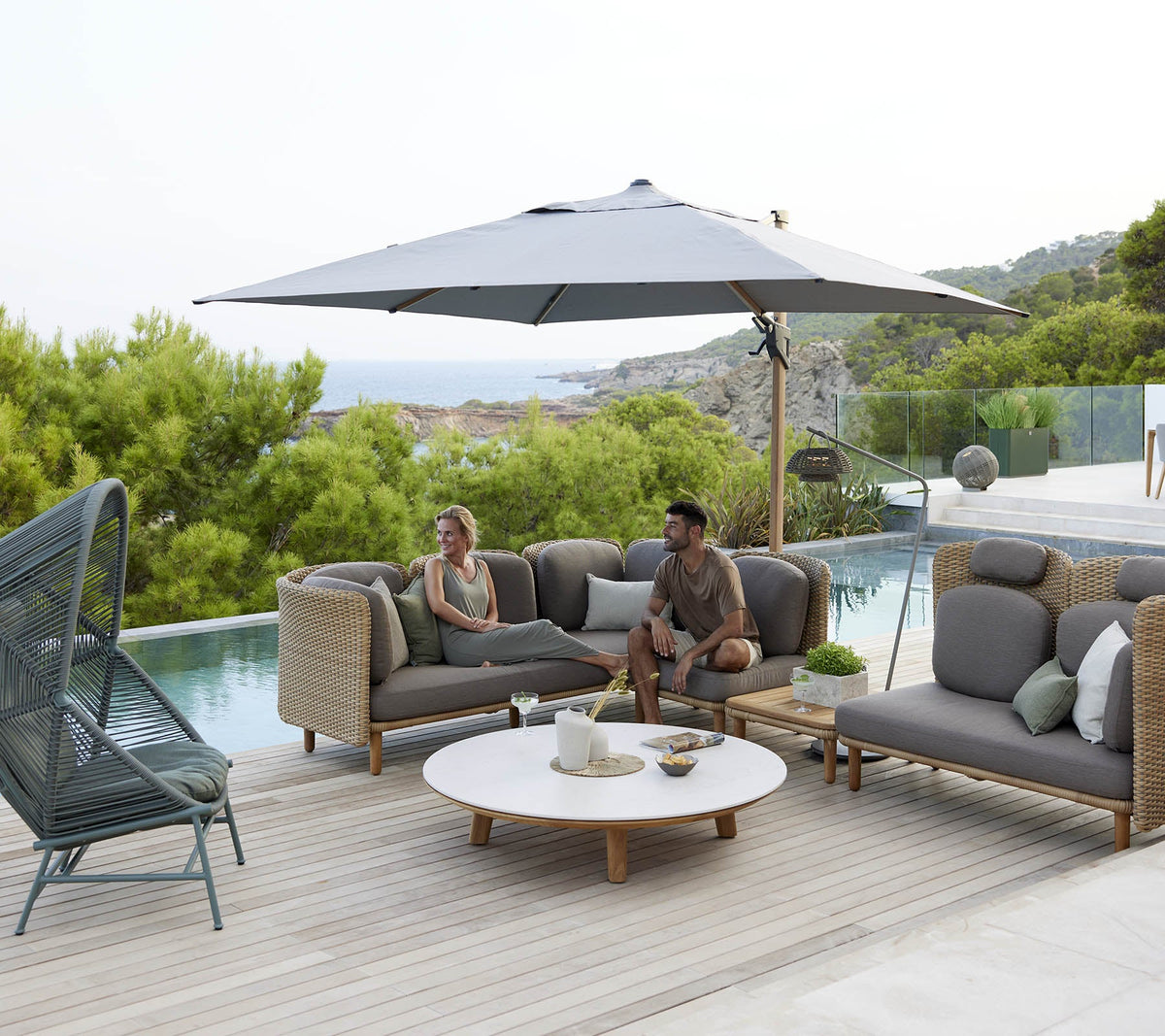 Aspect Coffee Table dia 144cm lifestyle image with Arch lounge and Hive seating by Cane-line