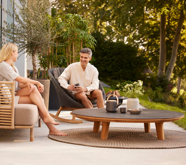 Aspect Coffee Table dia 144cm outdoor lifestyle setting with lounge seating by Cane-line