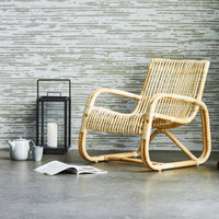 Curve lounge chair indoor lifestyle image by Cane-line