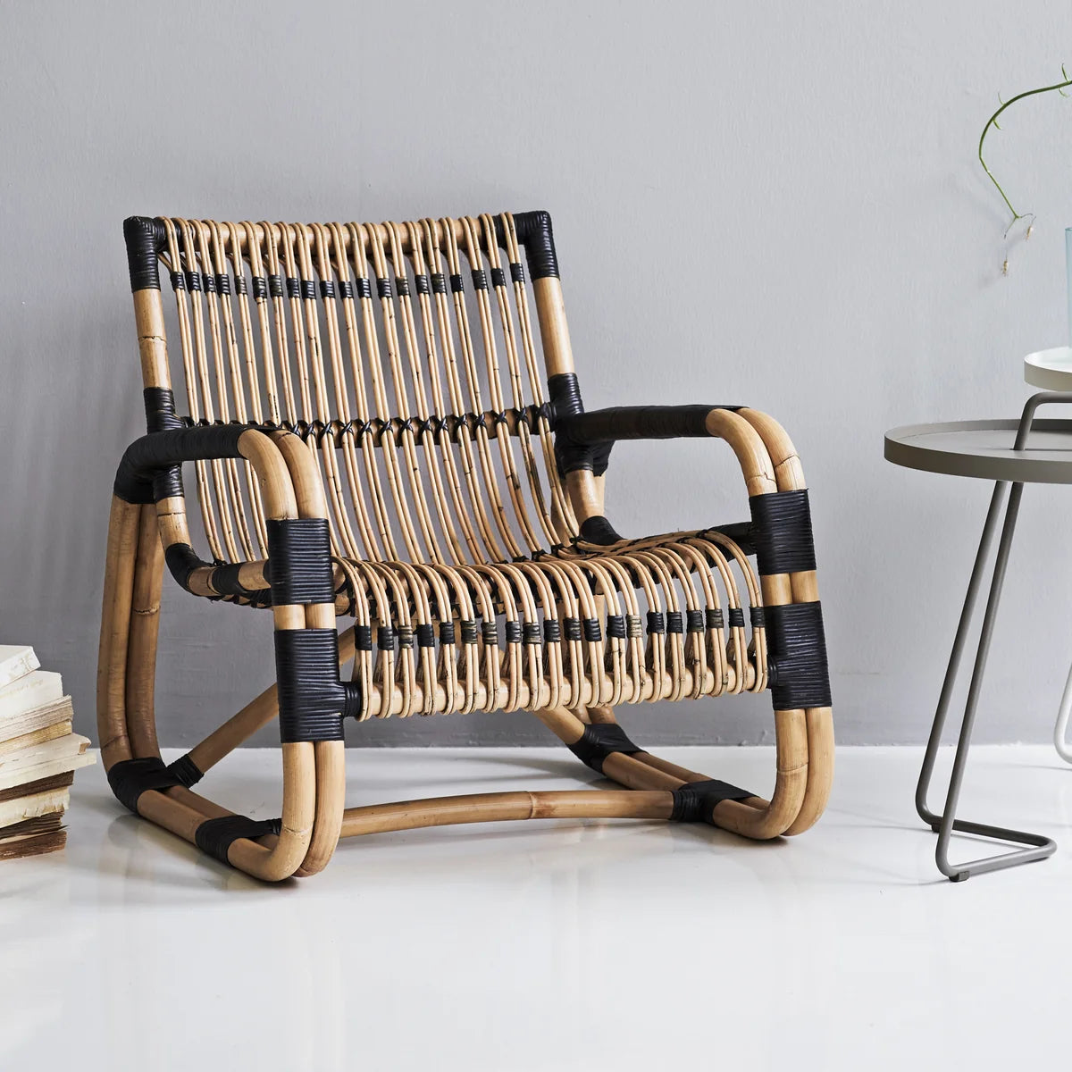 Curve lounge chair indoor setting by Cane-line