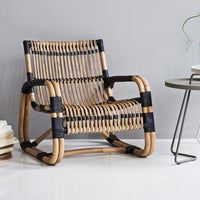 Curve lounge chair indoor setting by Cane-line