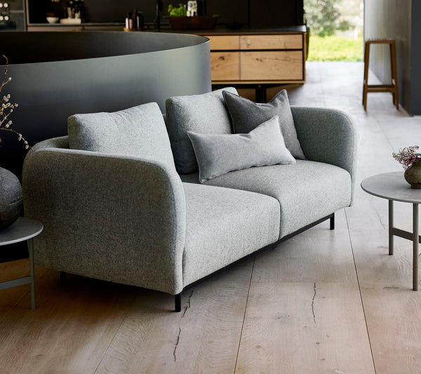 Aura 2-seater sofa lifestyle image by Cane-line, designed by Foersom & Hiort-Lorenzen MDD