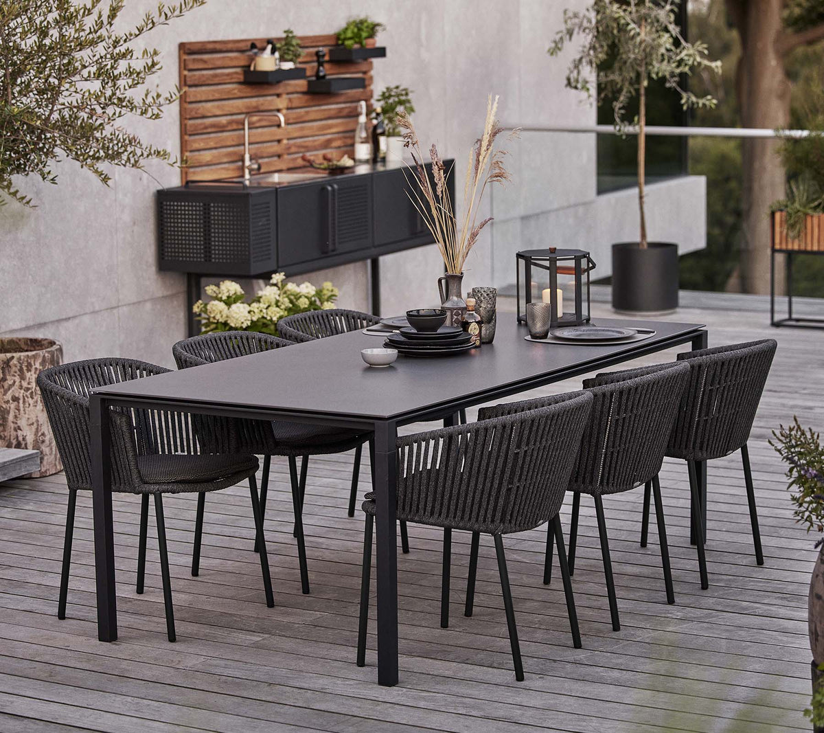 Cane-line Moments chair with outdoor dining table lifestyle image
