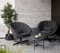 Peacock lounge chair with swivel aluminium base lifestyle by Cane-line