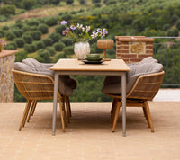 Stay outdoor dining chair lifestyle image with Core dining table by Cane-line