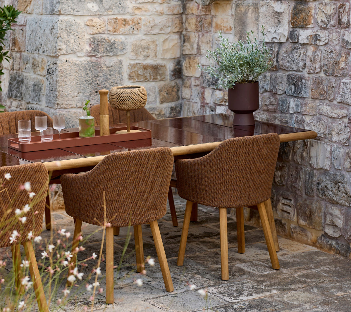 Sticks dining table lifestyle image with Choice chair and Club tray by Cane-line
