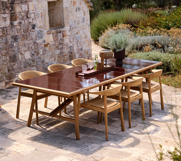 Sticks dining table lifestyle image with Majestic chair and Club tray by Cane-line