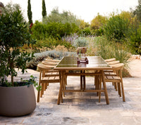 Sticks dining table lifestyle image with Majestic chair and Soil planter by Cane-line
