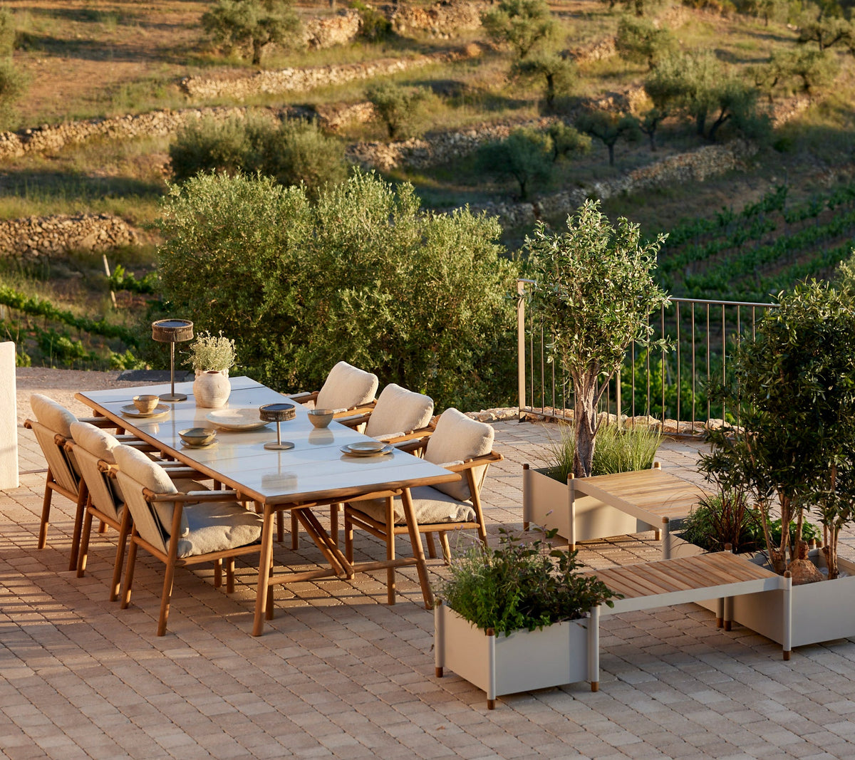 Sticks dining table with planter bench lifestyle image by Cane-line