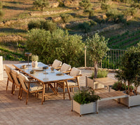 Sticks dining table with planter bench lifestyle image by Cane-line