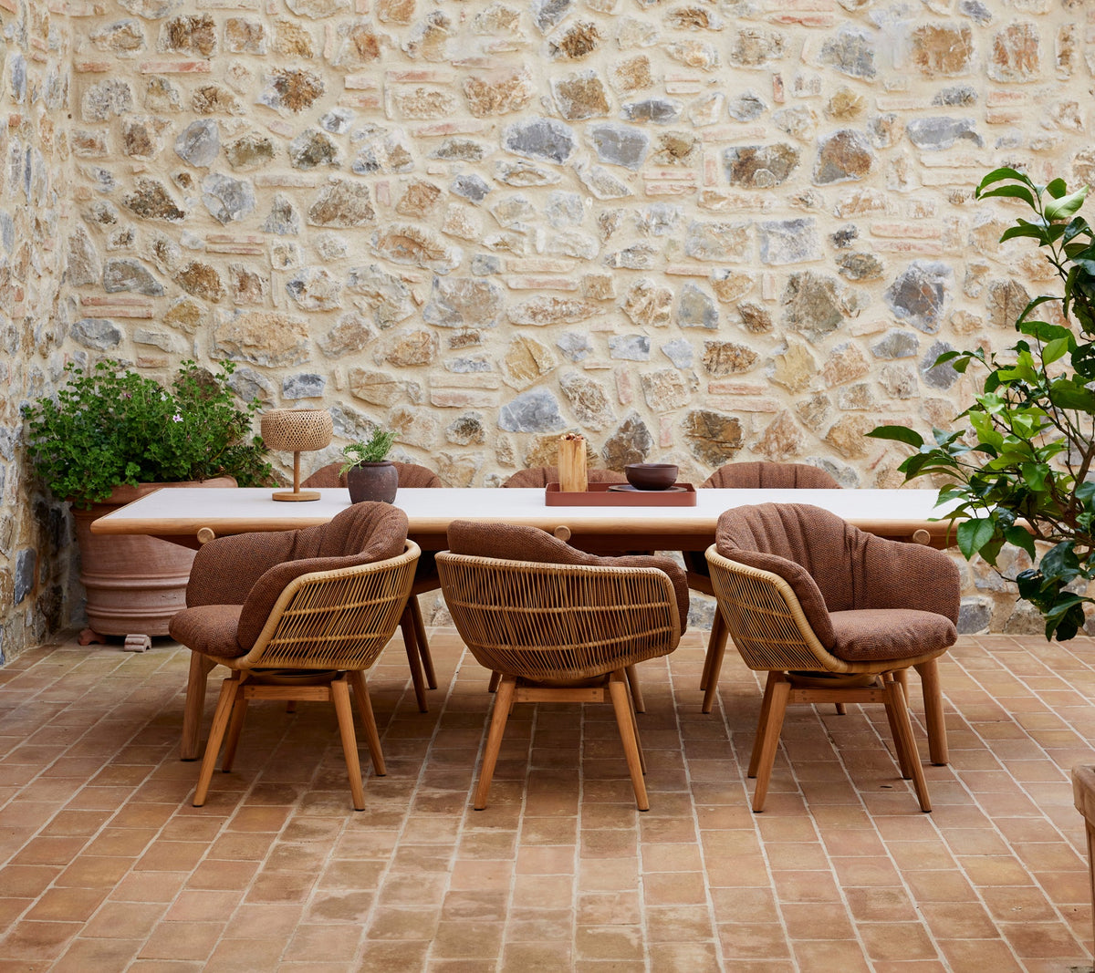 Sticks dining table lifestyle image with Stay dining chair by Cane-line