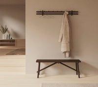 Sticks coat rack 120 cm in an indoor setting