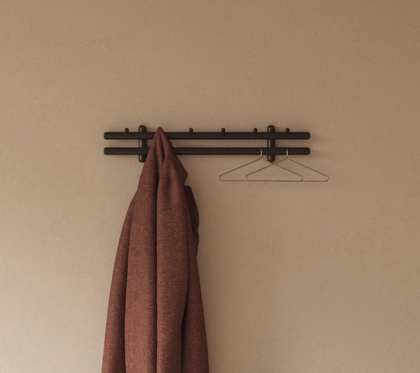 Sticks coat rack 80 cm in an indoor setting