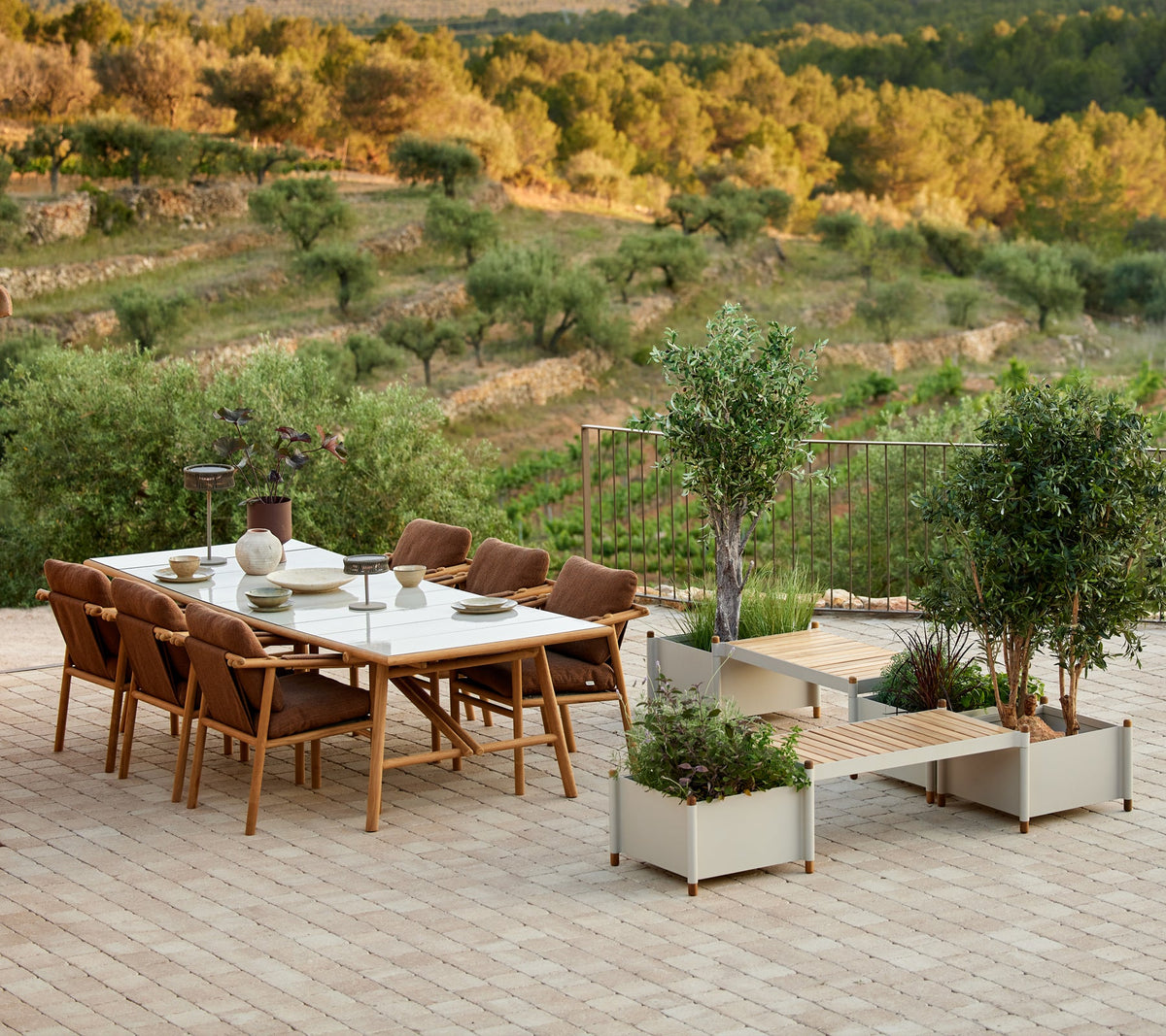 Sticks planter bench in an outdoor dining setting by Cane-line