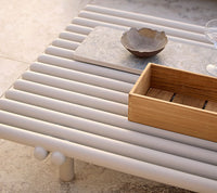 Sticks platform aluminium coffee table with storage box lifestyle image by Cane-line