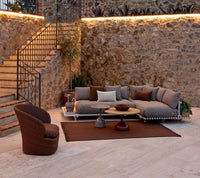 Sticks platform aluminium lifestyle image with Knit rug and Coast lounge chair by Cane-line