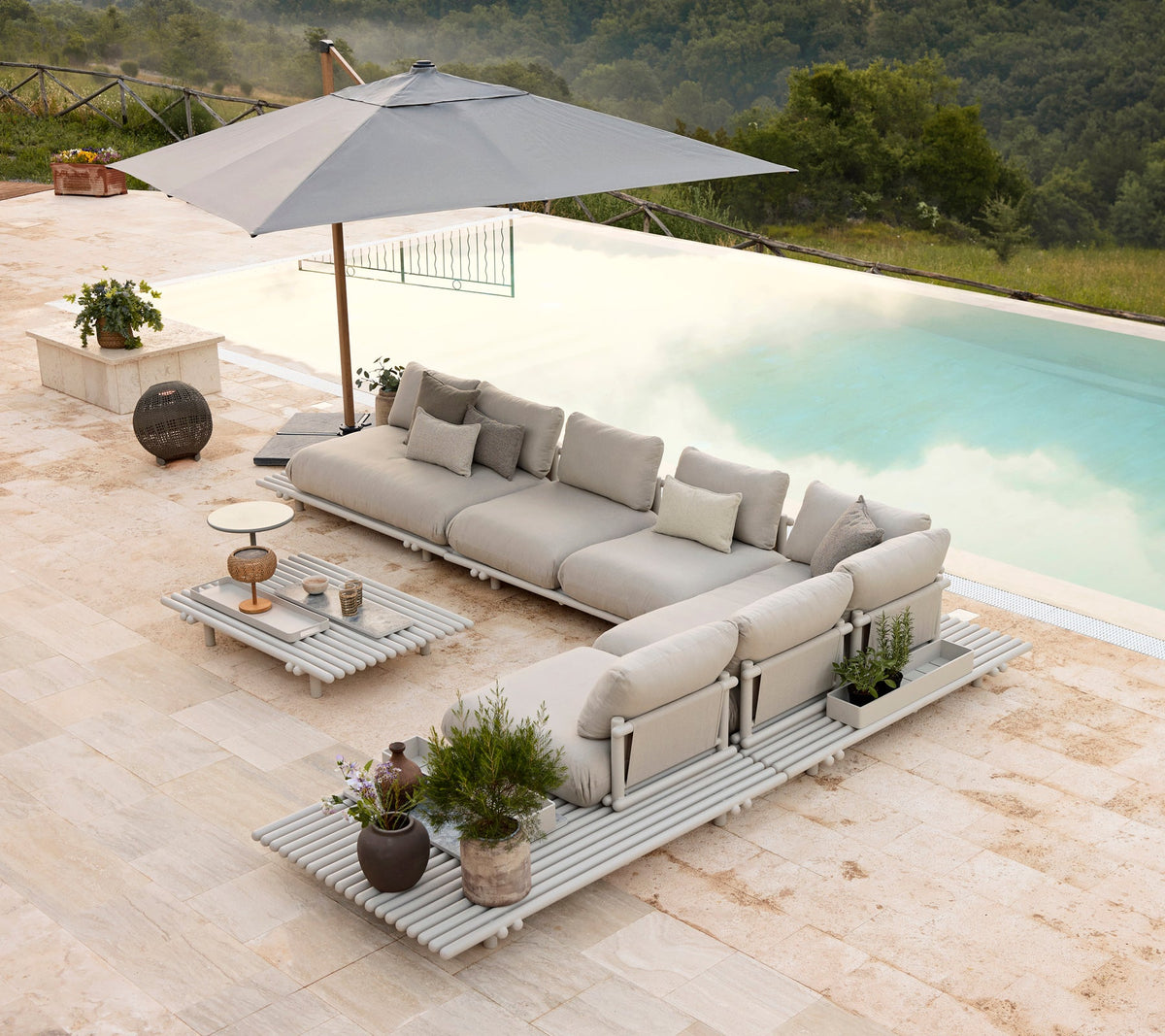 Sticks platform aluminium lounge lifestyle image with Sticks coffee table by Cane-line