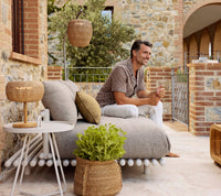 Sticks platform aluminium lifestyle image with On-the-move side table and Illusion Glow by Cane-line