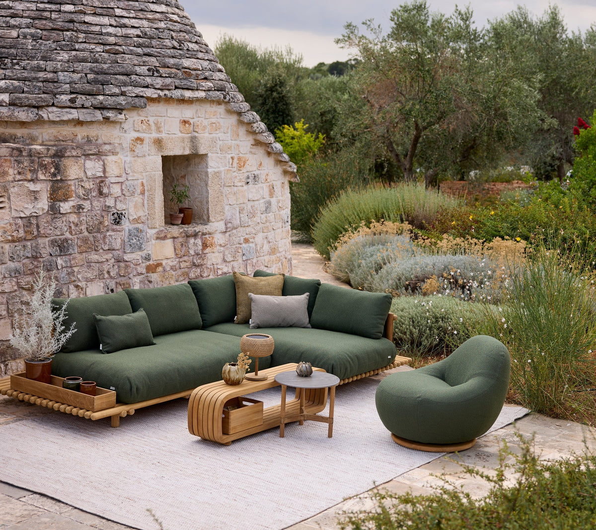 Sticks platform corner sofa lifestyle image with Gem lounge chair and Mellow coffee table by Cane-line