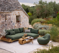 Sticks platform corner sofa lifestyle image with Gem lounge chair and Mellow coffee table by Cane-line