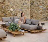 Sticks platform corner sofa teak lifestyle image with Sticks coffee table by Cane-line