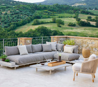 Sticks platform lounge aluminium lifestyle image with Moments lounge chair by Cane-line
