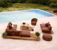 Sticks platform teak lifestyle image with Coast lounge chair and Circle footstool by Cane-line