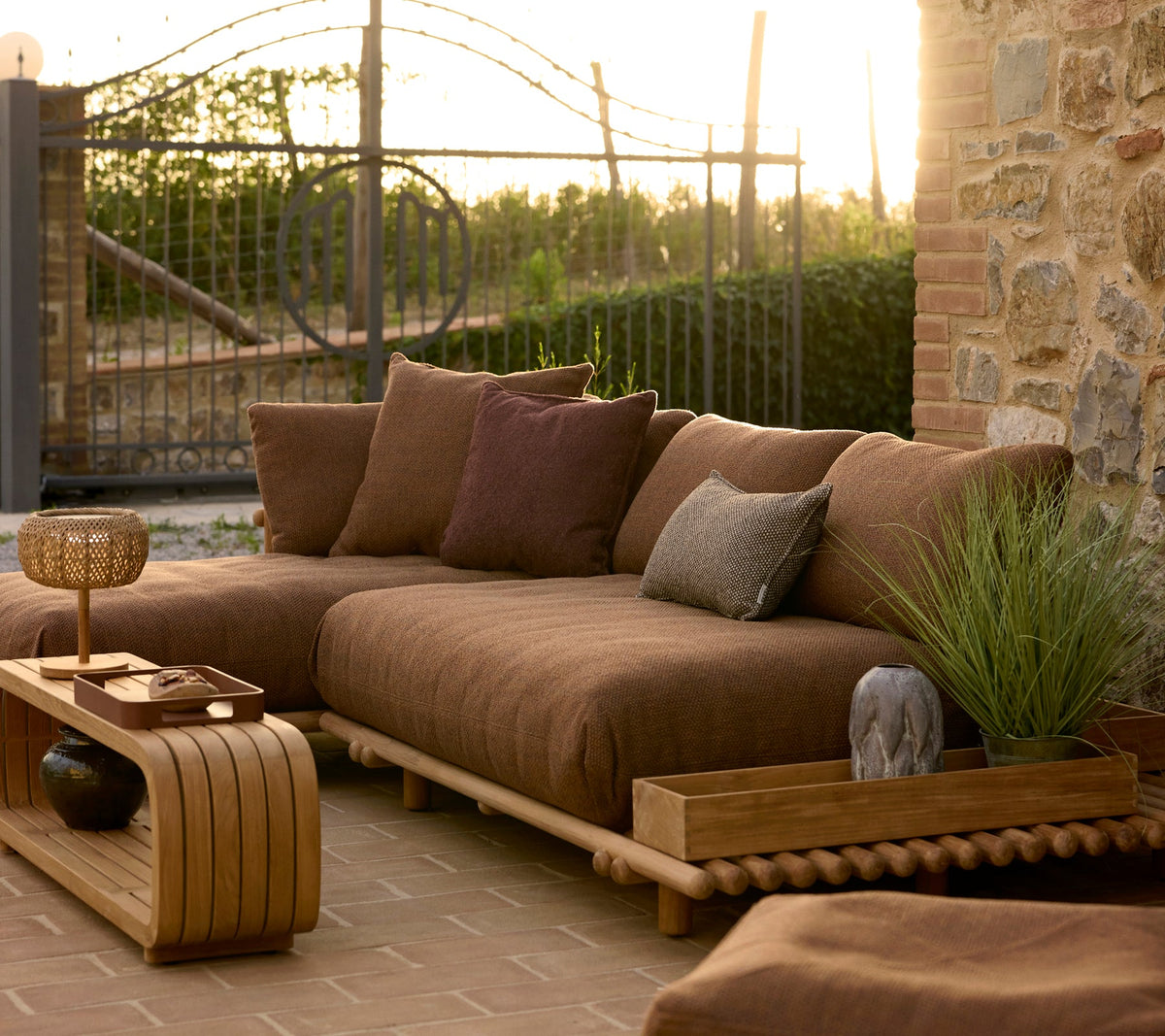 Sticks platform teak lifestyle image with Mellow coffee table and Club storage box by Cane-line