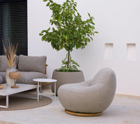 Cane-line Twist coffee table with lounge chair and planter