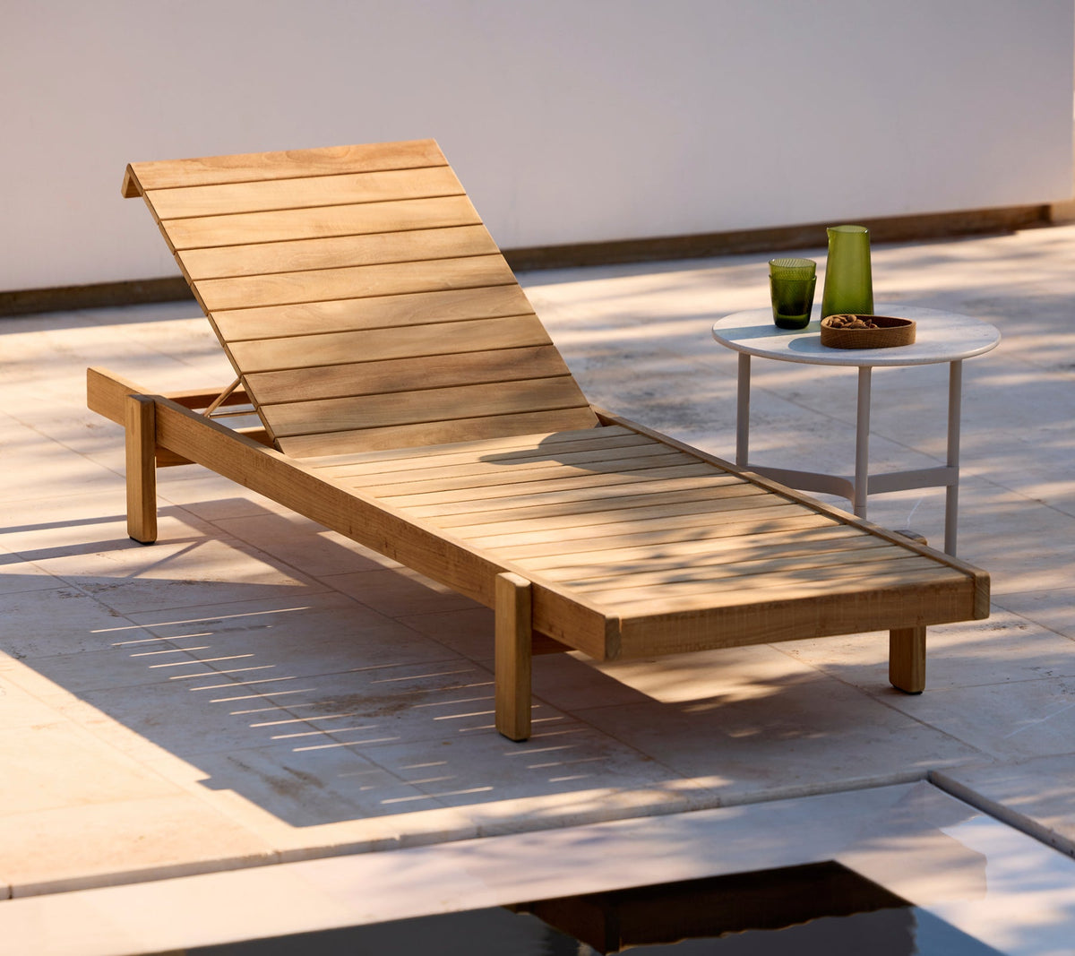 Cane-line Twist coffee table beside a teak sunbed