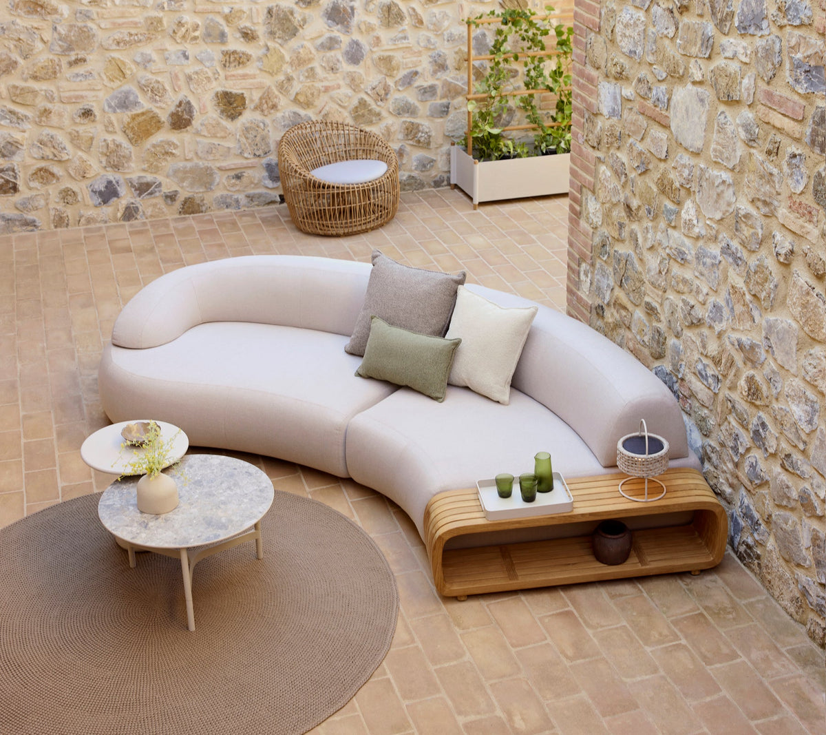 Cane-line Twist coffee table in a modern outdoor arrangement