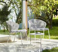 Cane-line Twist coffee table in a light outdoor setting