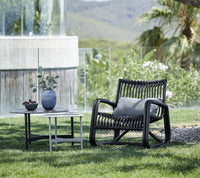 Cane-line Twist coffee tables beside modern lounge seating