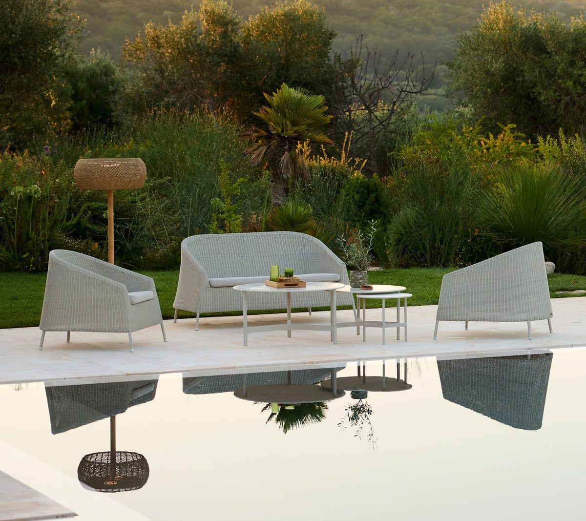 Cane-line Twist coffee table with lounge seating and floor lamp
