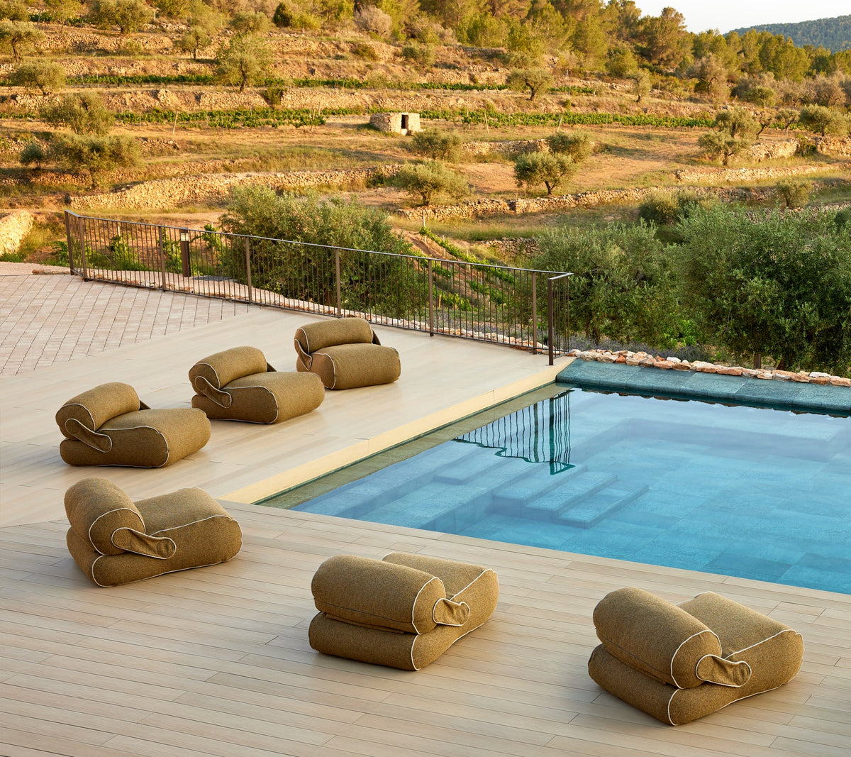 Unite Lounge Chair beside a pool in a modern outdoor lounge