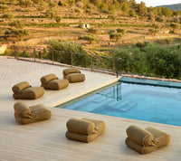 Unite Lounge Chair beside a pool in a modern outdoor lounge