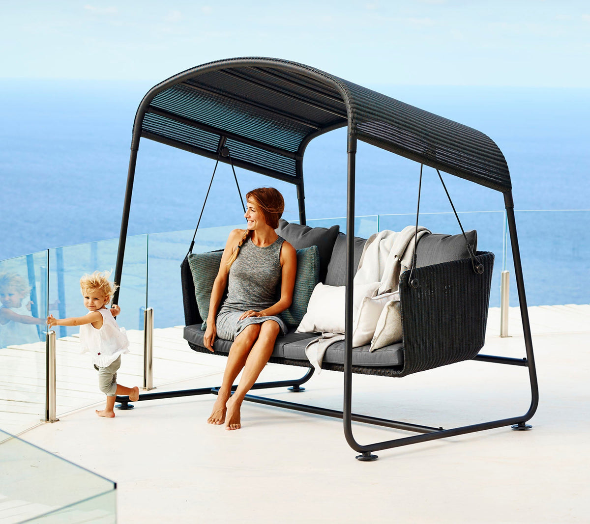 Cave Swing Sofa outdoor swing sofa by Cane-line, designed by Jesper K. Thomsen