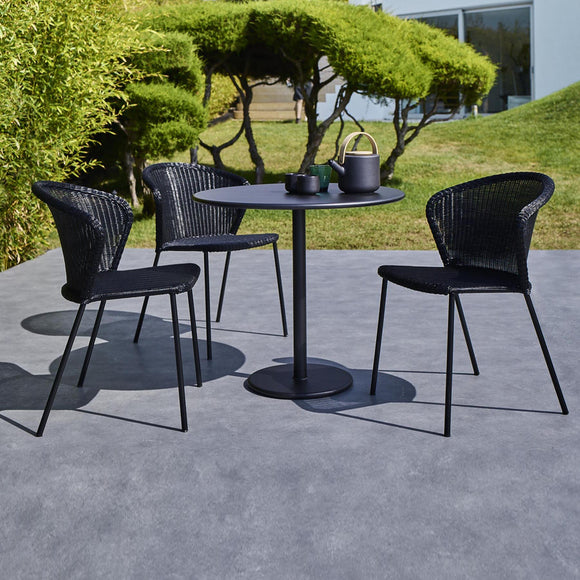 Lean chair outdoor dining lifestyle image by Cane-line