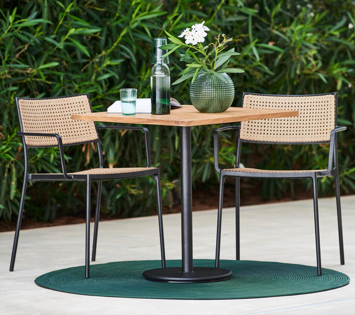 Less armchair natural outdoor dining lifestyle image by Cane-line