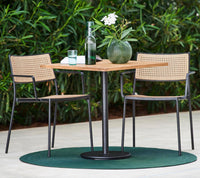Less armchair natural outdoor dining lifestyle image by Cane-line