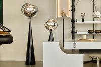 Melt Slim Cone Floor Light Copper Polished Polycarbonate floor light by Tom Dixon in a modern living room