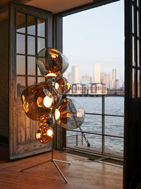Melt Floor Chandelier Gold Polished Polycarbonate floor light by Tom Dixon in a modern dining area