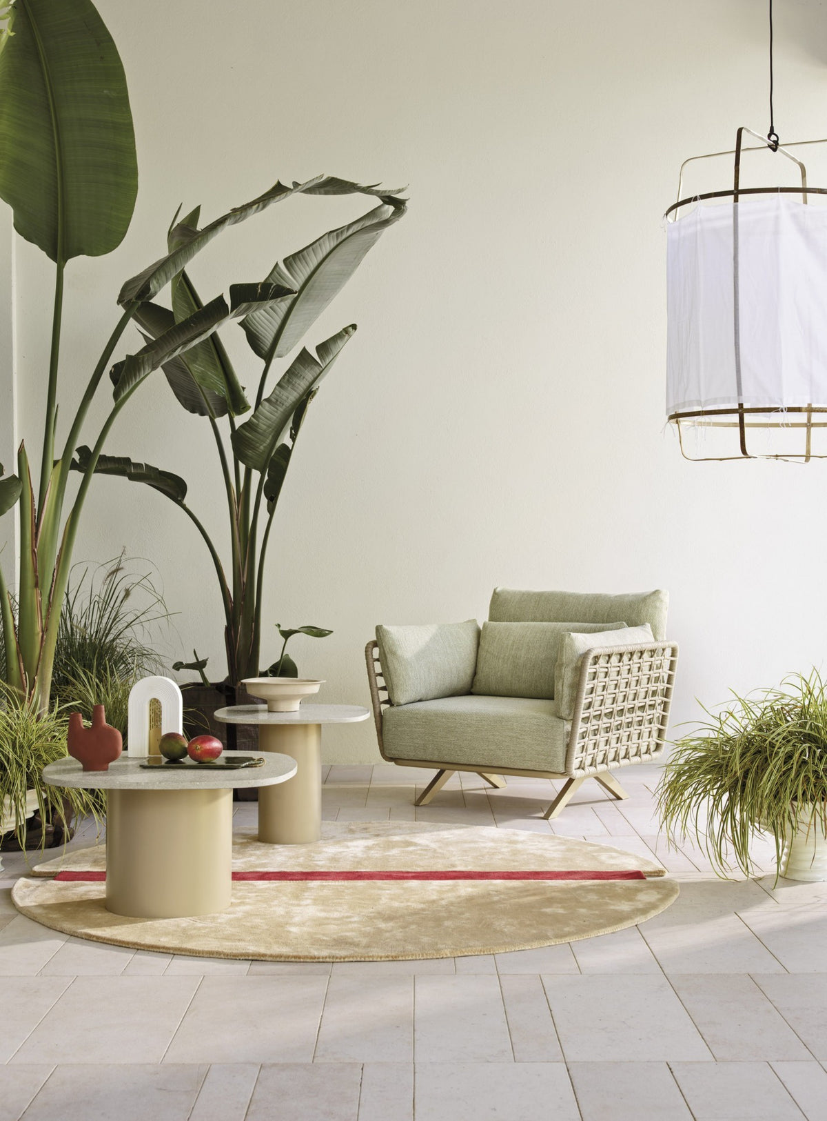 Roberti Armàn lounge chair with coffee tables in a covered setting