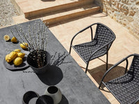 Roberti Capri 4301 chairs in Graphite beside an outdoor dining table