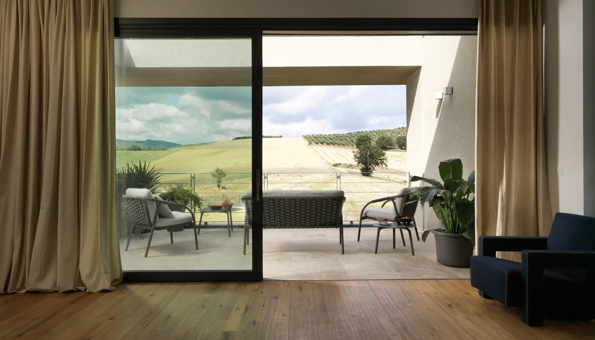 Roberti Capri 4311 lounge chairs and 4312 sofa in Graphite on a terrace