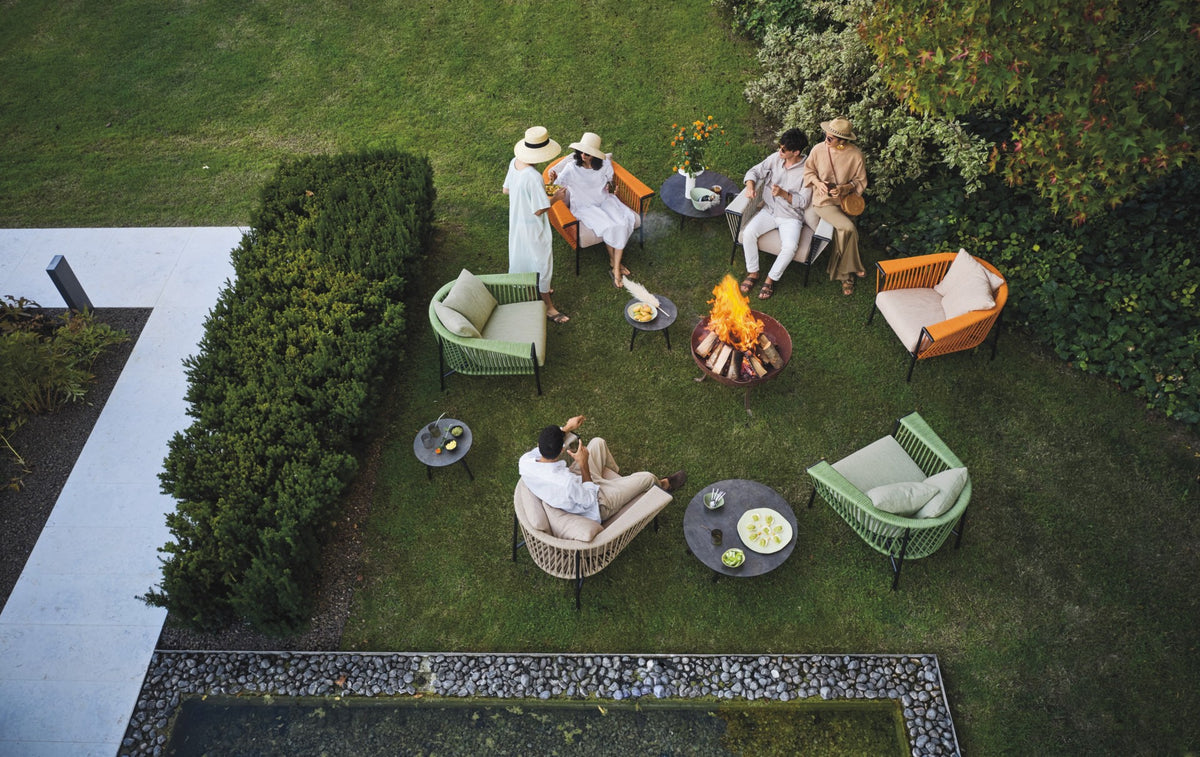 Roberti Corolle round coffee tables in a garden setting