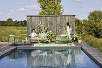 Roberti Corolle coffee tables beside a pool